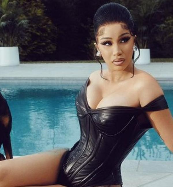 Cardi B poses by pool with dog. 