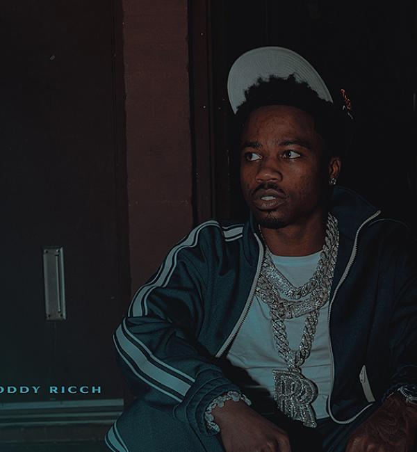Roddy Ricch - Aston Martin Truck official artwork - Roddy sits on stairs. 